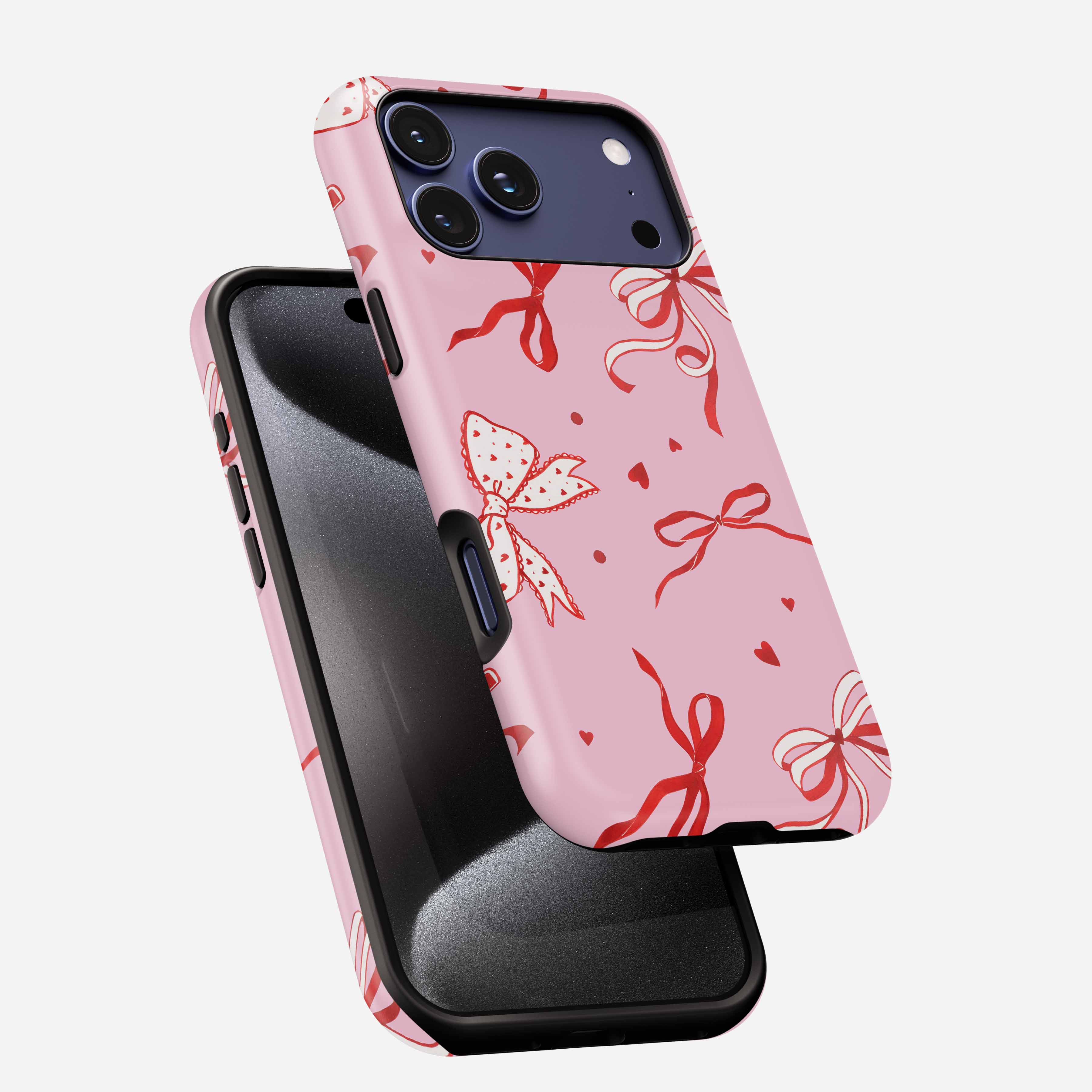 Pink phone case with red ribbon and bow pattern, triple camera cutout, MagSafe compatible.