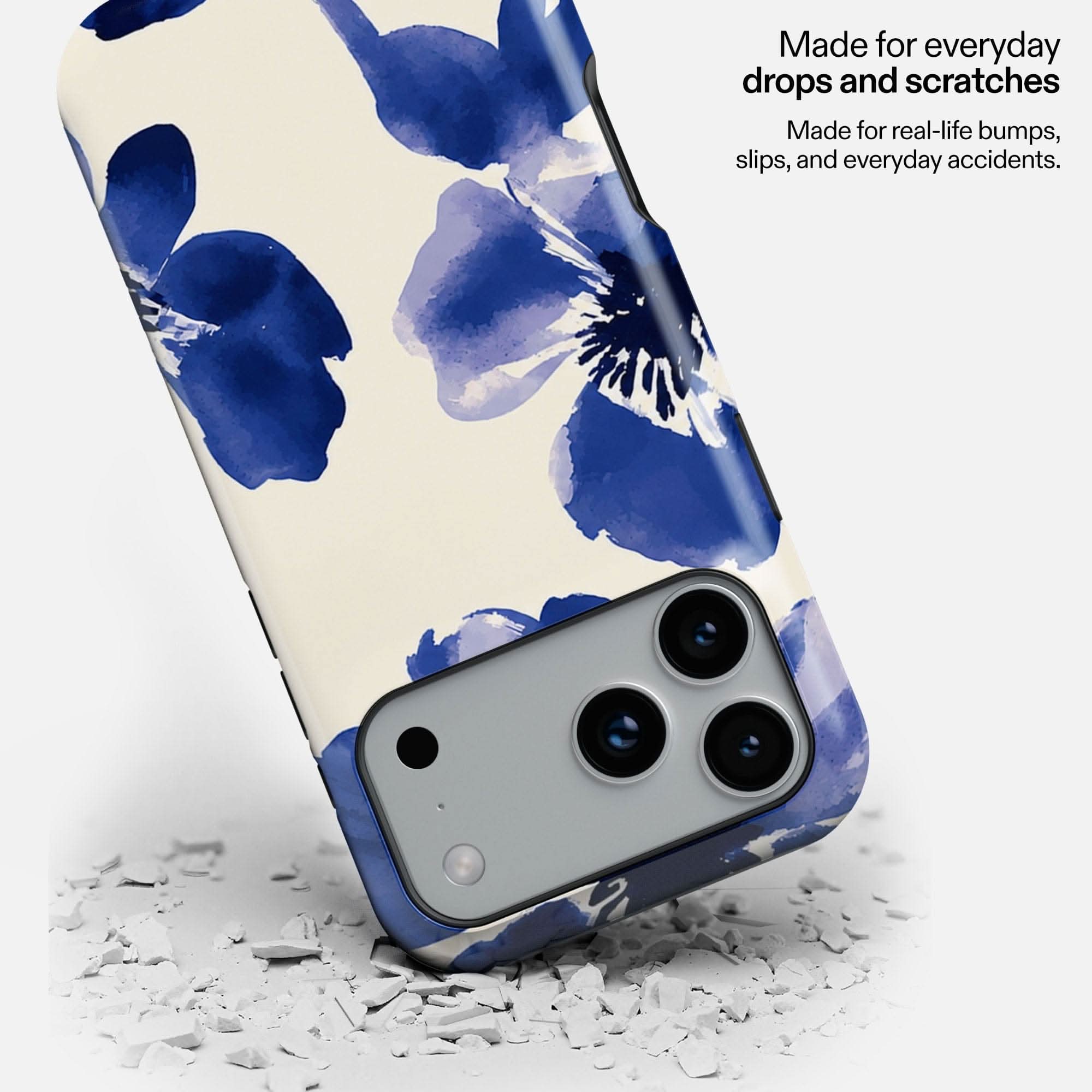 Blue Muse MagSafe Tough Phone Case with watercolor floral design, displayed on white debris surface.